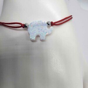 Lucky Glow – White Opal Elephant on Red String Bracelet
